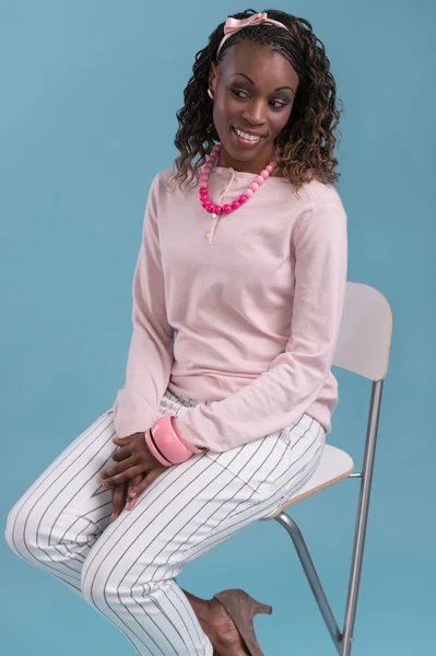 African woman sitting on   chair — Stock Photo, Image