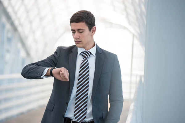 Businessman looking at watches — Stock Photo, Image