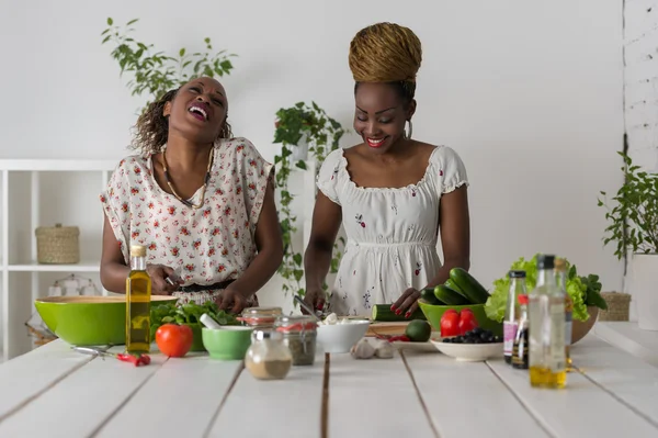 Two african women cooking salad — Stock Photo, Image