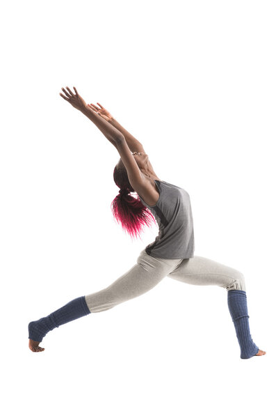 Woman practicing Warrior yoga pose