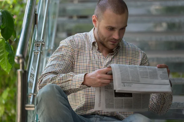 Man reading newspaper and thinking — Stock Photo, Image