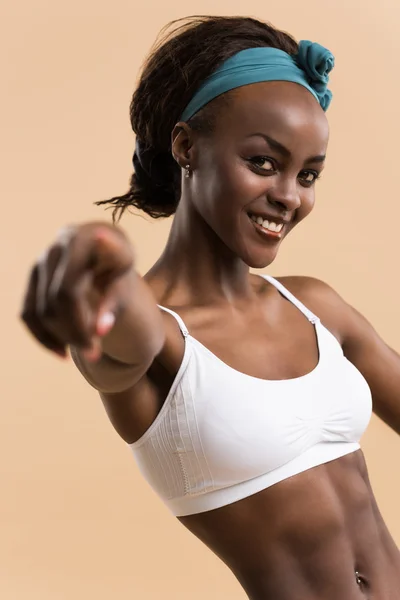 Athletic girl pointing at camera — Stock Photo, Image