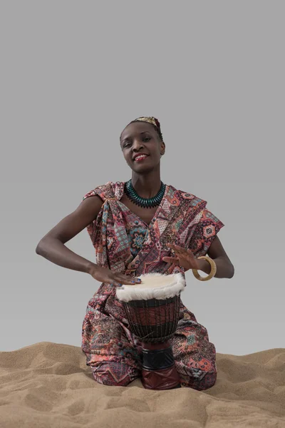 African woman playing traditional drum — Stock Photo, Image