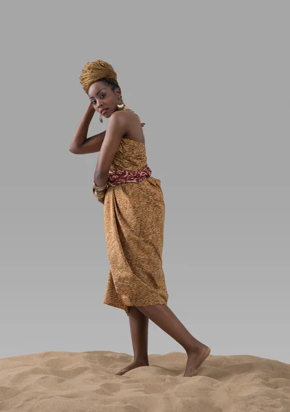 African fashion woman standing on sand — Stock Photo, Image