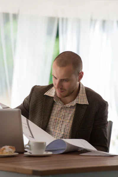 Businessman working with blueprints — Stock Photo, Image