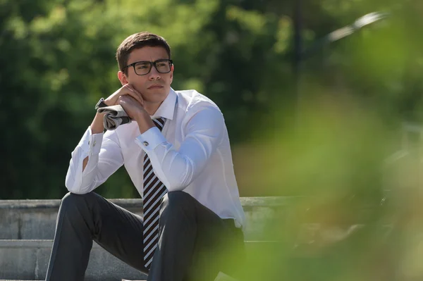 Businessman resting on stairs — Stock Photo, Image