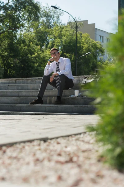 Хорошо одетый бизнесмен курит — стоковое фото