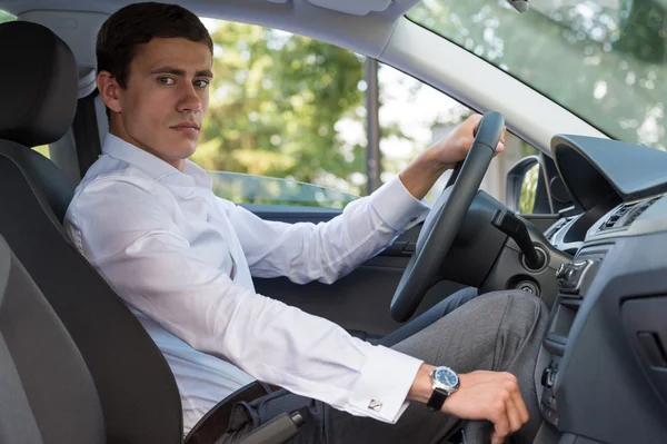 Young man driving car — Stock Photo, Image