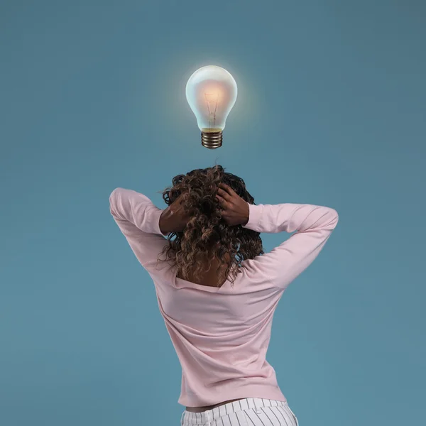 Woman thinking with light bulb — Stock Photo, Image