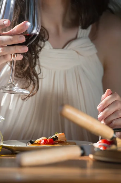 Frau isst Pizza und trinkt Wein — Stockfoto