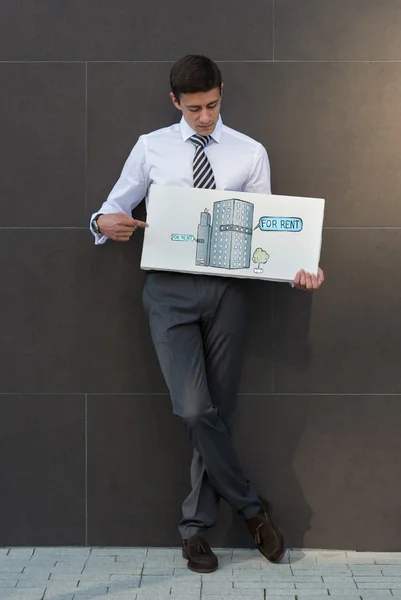 Businessman offering office for rent — Stock Photo, Image