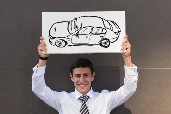 Homem de negócios com sinal de carro novo — Fotografia de Stock