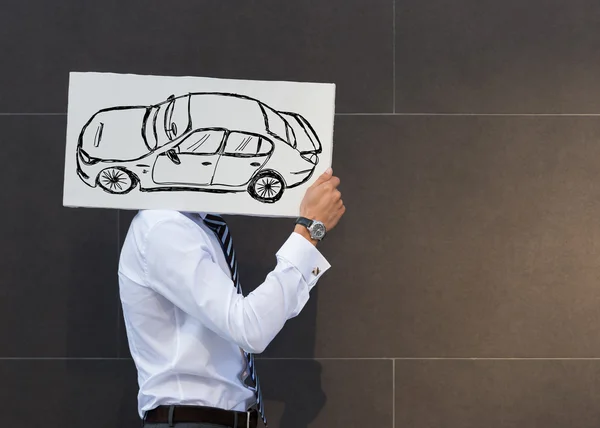 Geschäftsmann mit neuem Autoschild — Stockfoto