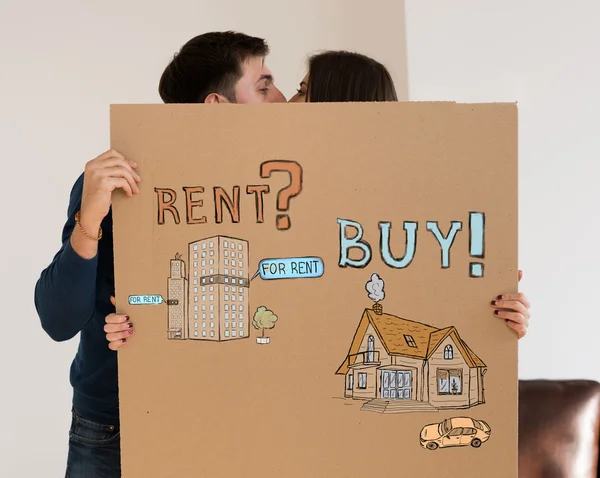 Couple hiding behind Mortgage concept sign — Stock Photo, Image