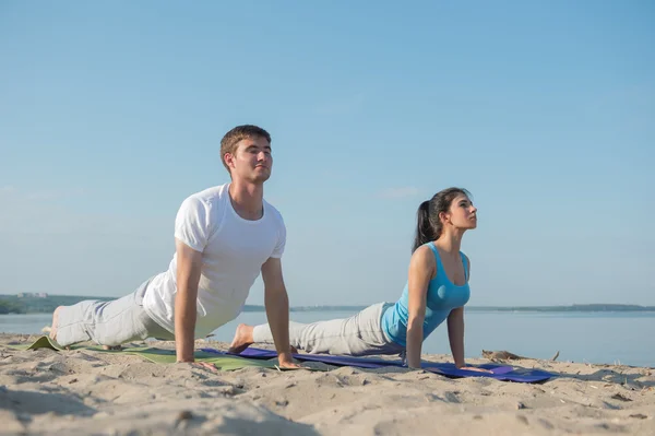 Yoga yaparken genç Çift — Stok fotoğraf