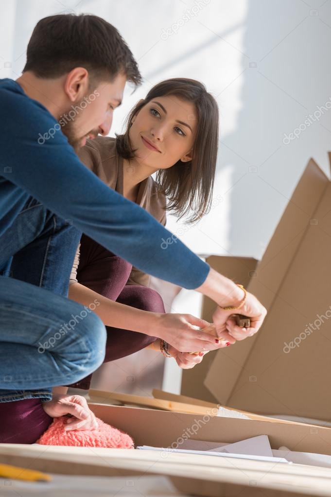 Couple assembling furniture