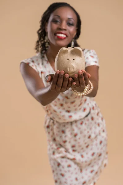 African woman with piggy moneybox — Stock Photo, Image