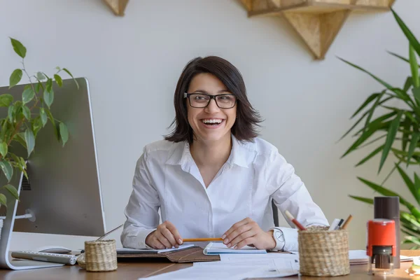 Mulher sorrindo no escritório — Fotografia de Stock