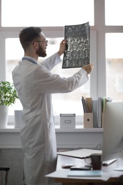 Doctor looking at brain x-ray clipart