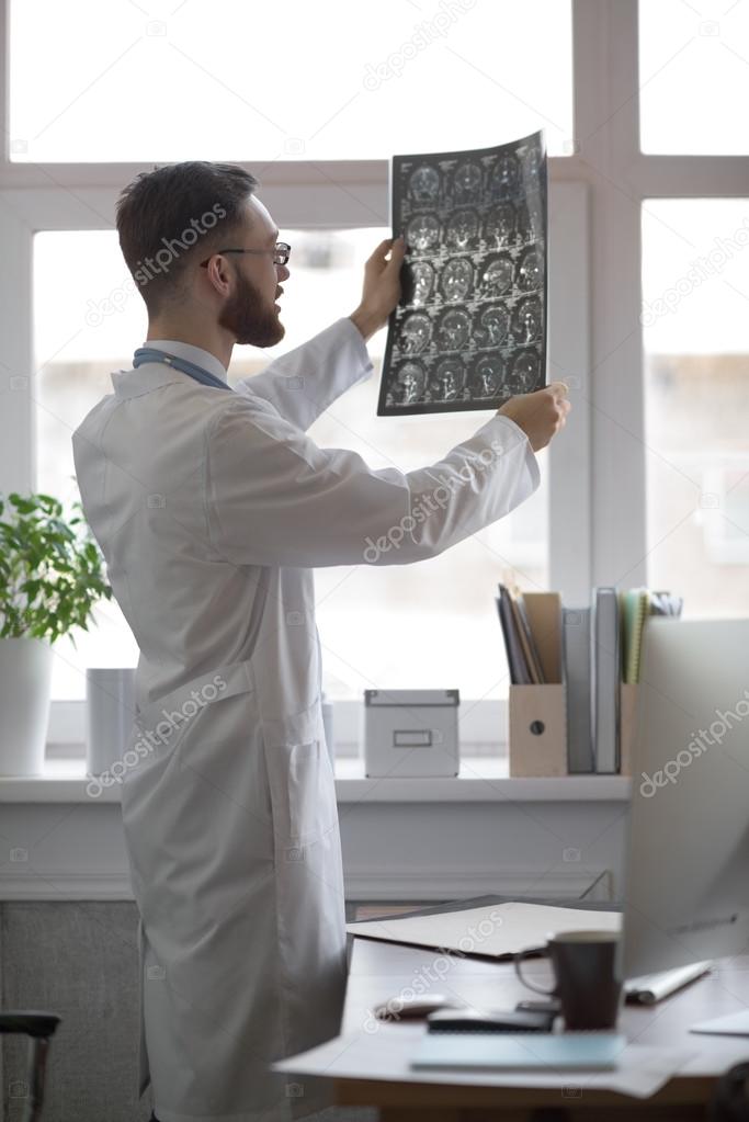 Doctor looking at brain x-ray