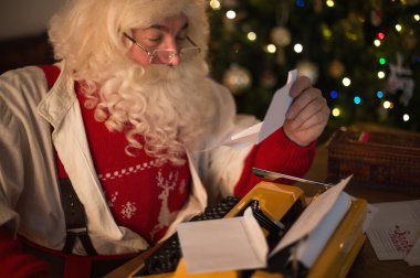 Santa Claus responding to children's letters clipart