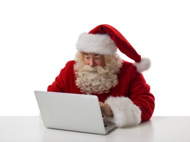 Santa Claus working with laptop clipart