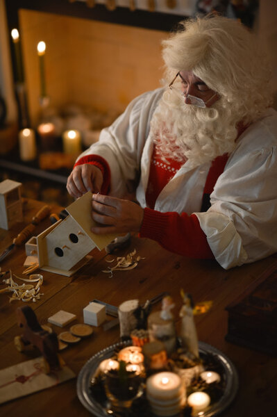 Santa Claus making wooden toys