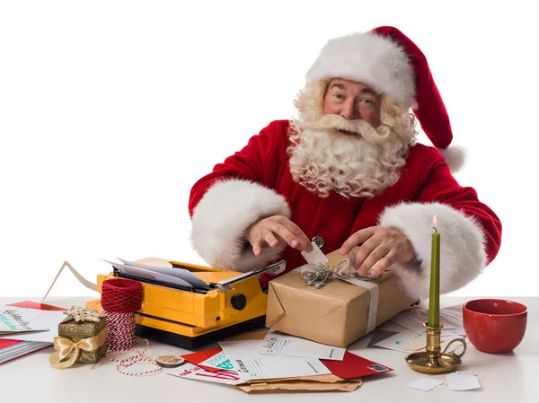 Santa Claus wrapping gift — Stock Photo, Image