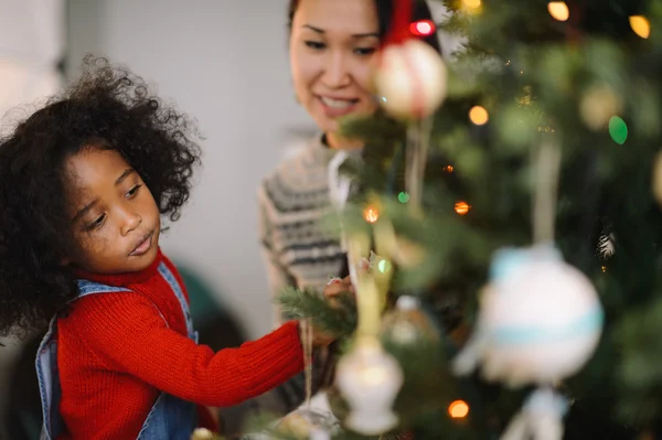 Mother and daughter playing at Christmas time — Stock Photo, Image