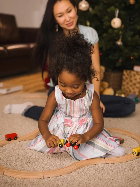 Mother and daughter playing at Christmas time — Stock Photo, Image