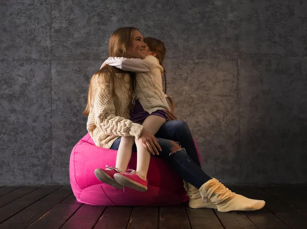 Sisters on Beanbag Hugging — Stock Photo, Image