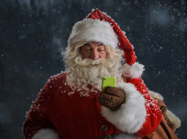 Santa Claus using mobile phone — Stock Photo, Image