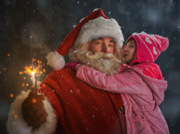 Santa Claus with Child burning sparkler — Stock Photo, Image