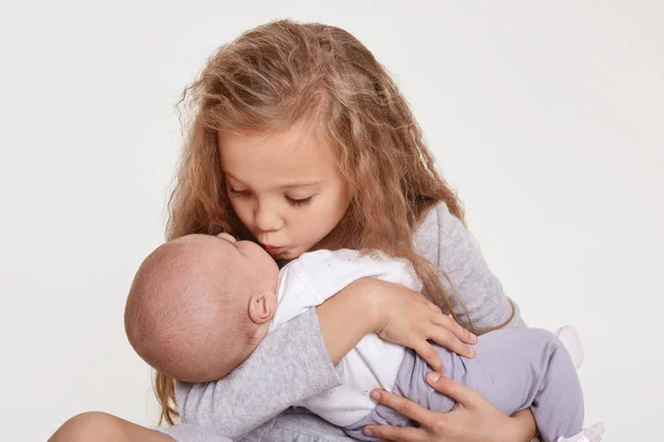 Happy Sister Kisses Baby Girl Sitting White Background Blond Female — Stock Photo, Image