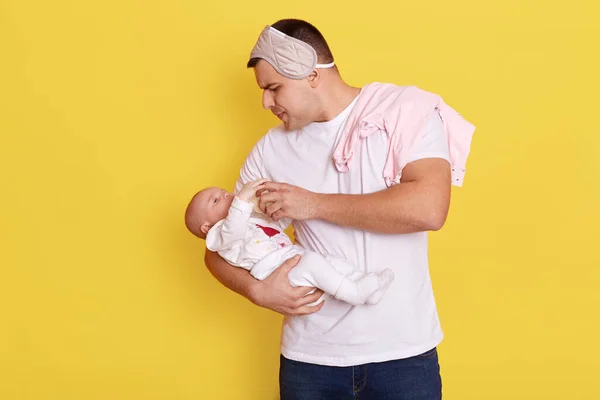 Young Father Holding Feeding Her Baby Isolated Yellow Background Handsome — Stock Photo, Image