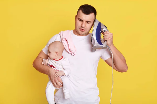 Handsome Young Dad Looking Newborn Baby Needs Ironing Holds Iron — Stock Photo, Image