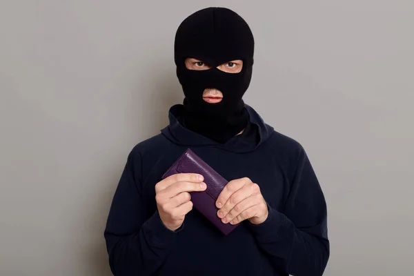 Serious Young Man Burglar Robbery Mask Black Sweater Holds Tightly — Fotografia de Stock
