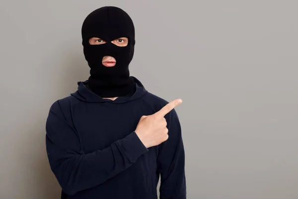 Male Thief Dressed Black Turtleneck Robbery Mask Points His Index — Fotografia de Stock