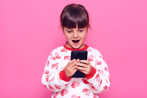 Happy Excited Female Child Wearing Jumper Hearts Holding Cell Phone — Stock Photo, Image