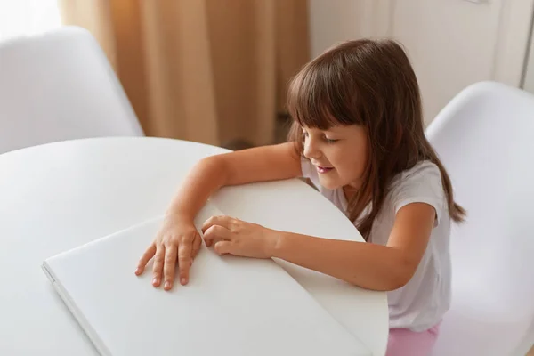 Cute Little Girl Sitting Table Her White Closed Laptop Dark — Stock Photo, Image