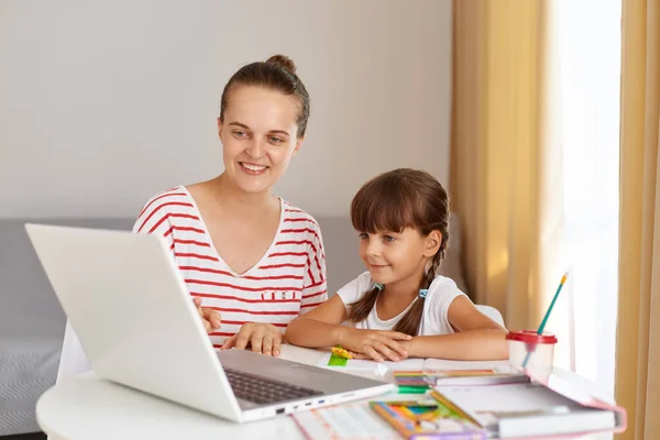 Retrato Feliz Madre Sonriente Sentada Lado Pequeña Hija Colegiala Haciendo —  Fotos de Stock