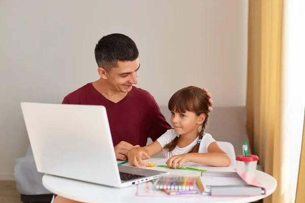 Indoor Shot Positive Father Little Daughter Doing Homework Home Sitting —  Fotos de Stock