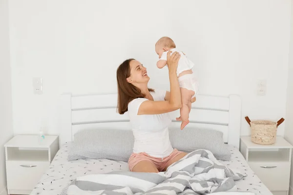 Indoor Shot Positive Smiling Young Mother Playing Her Infant Baby — Stock Photo, Image