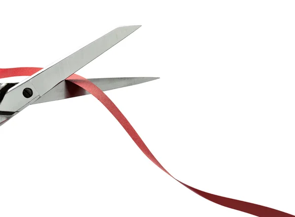 Scissors cutting a red ribbon. clipping path — Stock Photo, Image