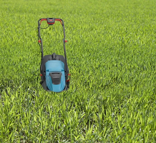 Lawn mower surrounded by high grass. — Stock Photo, Image