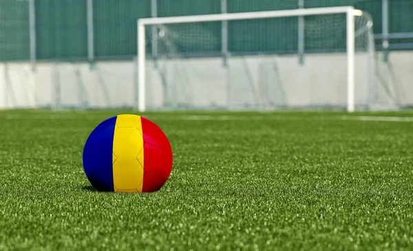 Soccer ball on the green field- flag Romania — Stock Photo, Image