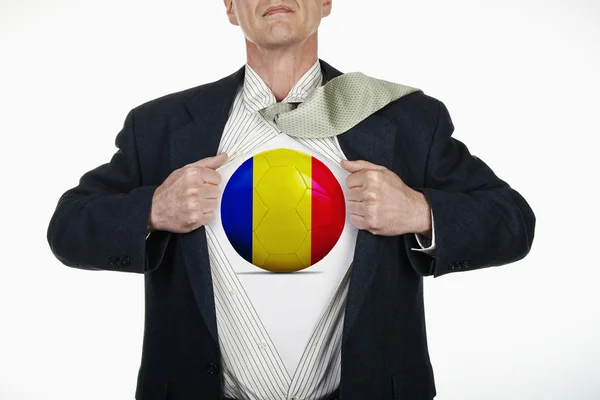 Supereroe tirando camicia aperta con pallone da calcio - Romania — Foto Stock