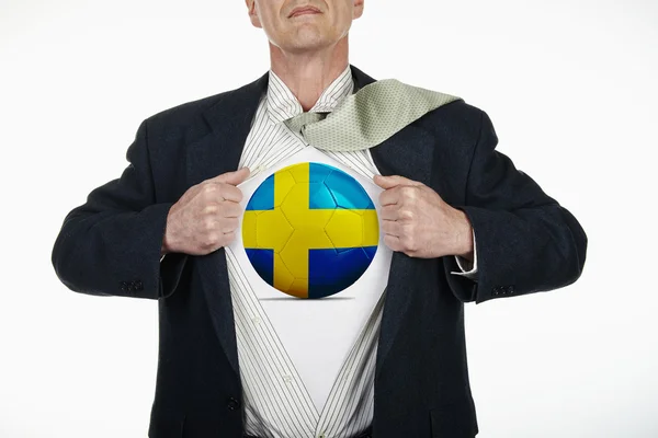 Superhero pulling Open Shirt with soccer ball - Sweden — Stock Photo, Image