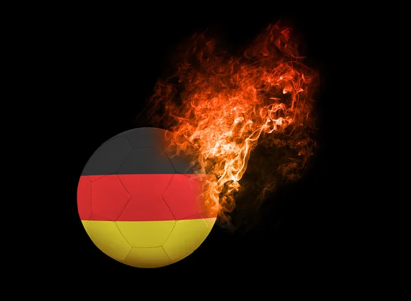 Pallone da calcio fiammeggiante su bandiera di sfondo nero Germania — Foto Stock