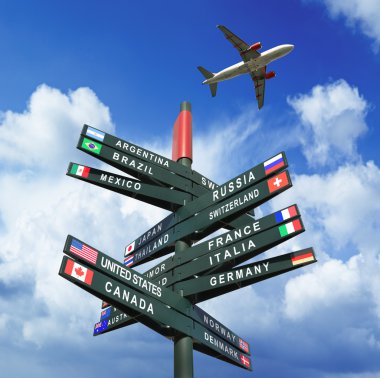 Yol işaret gökyüzünde uçak ülkeden, bayraklı